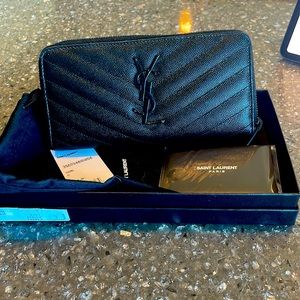 YSL black pebbled leather zip around wallet.